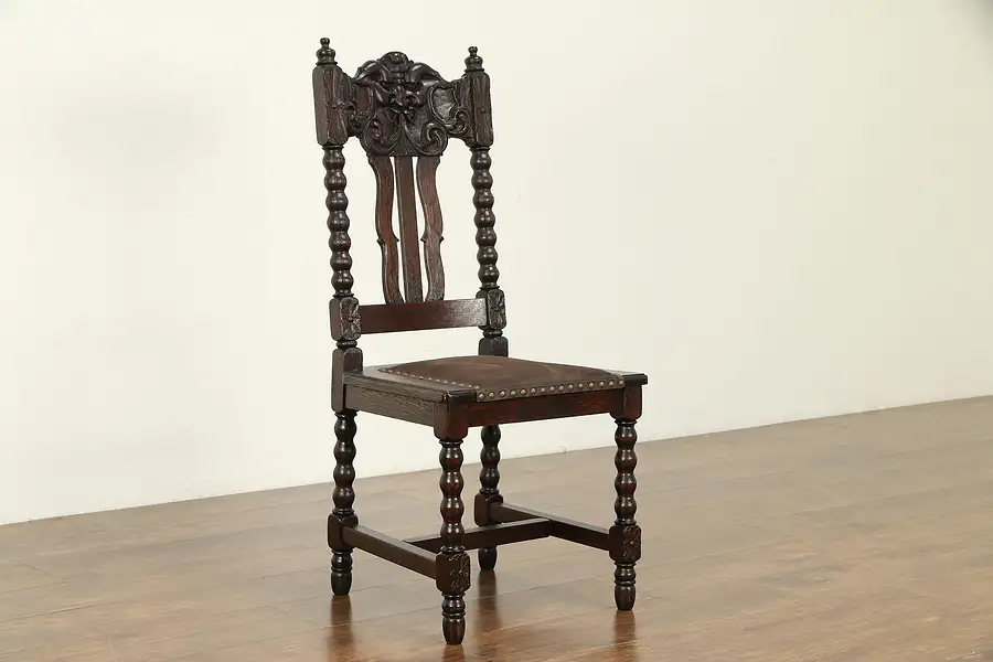 Main image of Antique Oak Dining Chair, New Leather, North Wind Face Carving