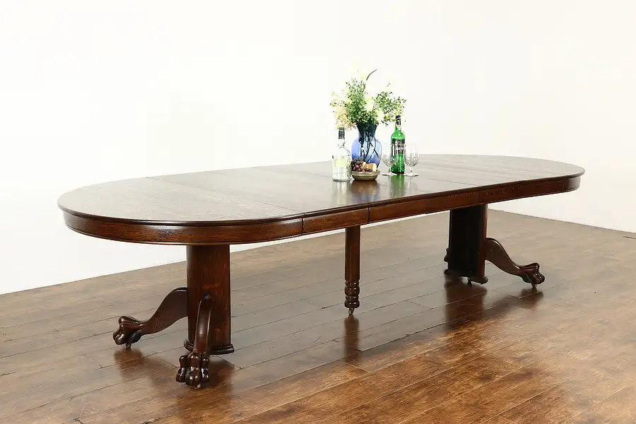 Main image of Round Oak Antique 52" Dining Table, 5 Leaves, Paw Feet, Extends 10'