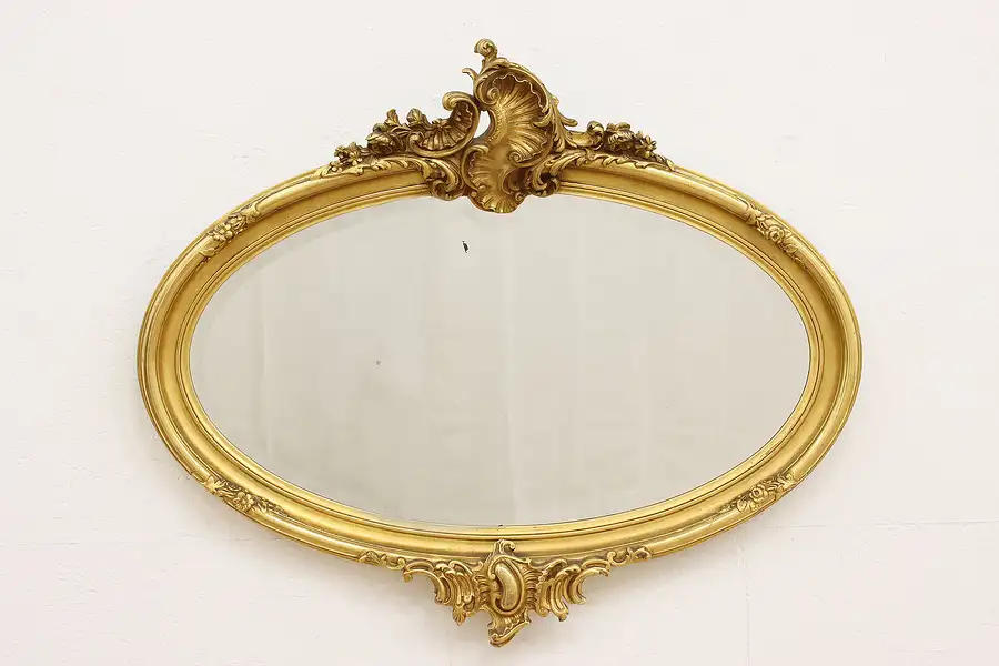 Main image of French Antique Carved Burnished Gold Oval Beveled Mirror